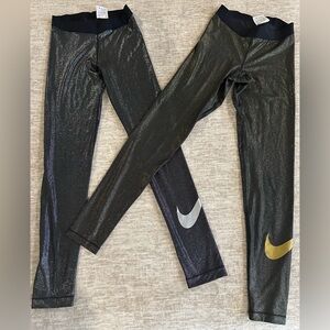 Lot of 2: Nike, glitter leggings w/leg logo. One silver, one gold. Both sz med